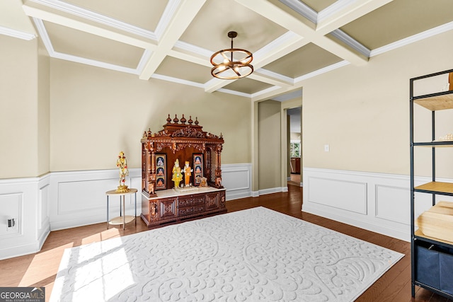 bedroom featuring hardwood / wood-style flooring, beam ceiling, ornamental molding, and coffered ceiling