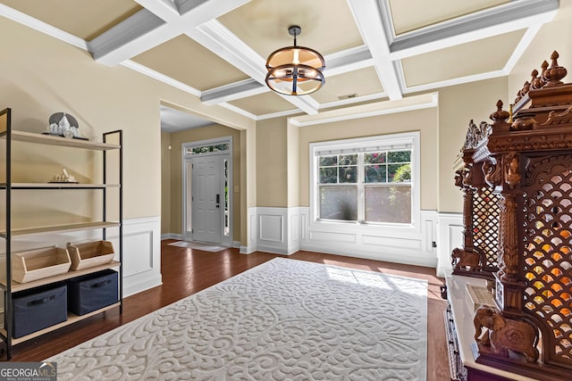 entrance foyer featuring beamed ceiling, dark hardwood / wood-style flooring, ornamental molding, and coffered ceiling