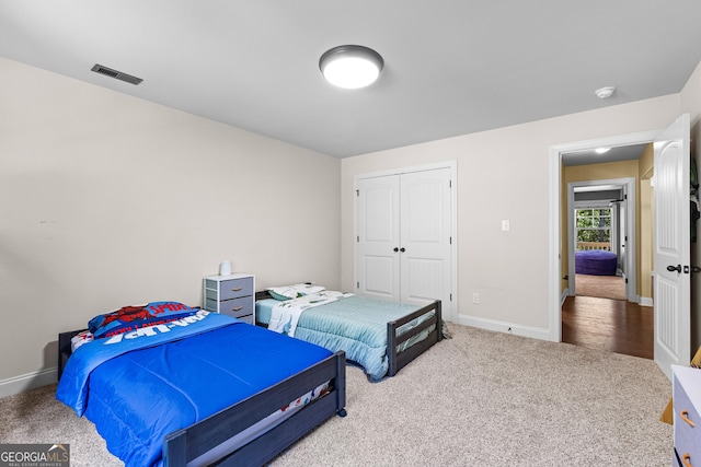 carpeted bedroom featuring a closet