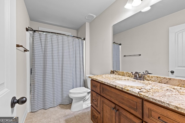 bathroom featuring toilet, vanity, tile patterned floors, and walk in shower