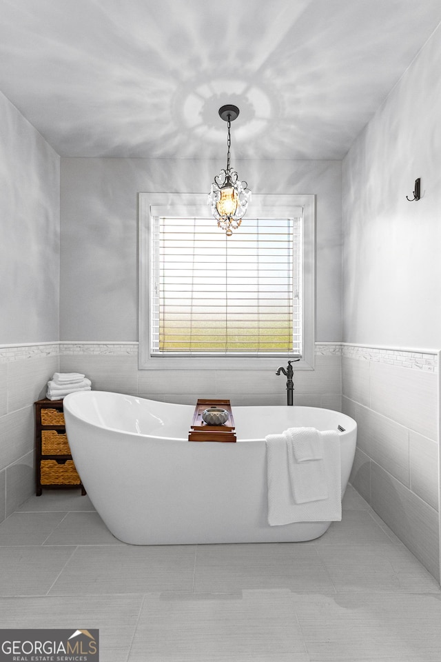 bathroom featuring a bathing tub, tile walls, and tile patterned floors