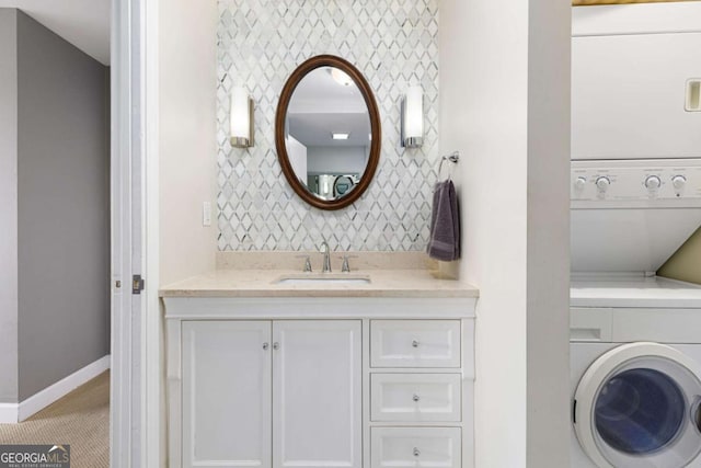 bathroom with vanity and stacked washer / dryer