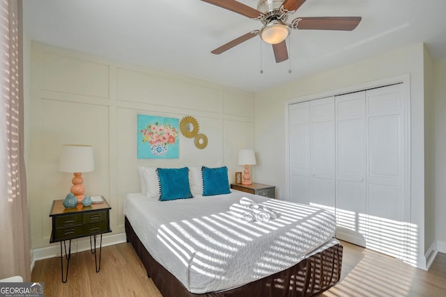 bedroom featuring light wood-type flooring, a closet, and ceiling fan