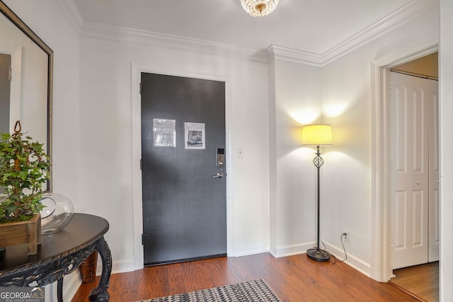 foyer entrance with crown molding and dark wood-type flooring