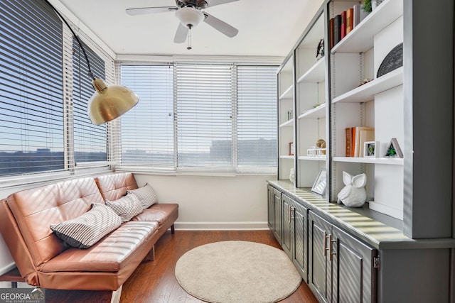 sitting room featuring ceiling fan, a healthy amount of sunlight, and wood-type flooring