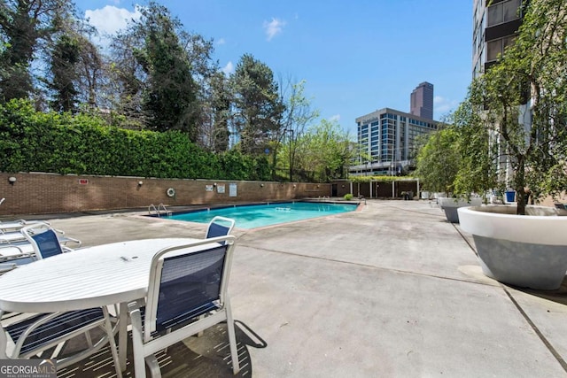 view of swimming pool with a patio area