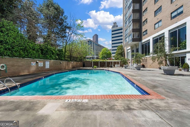 view of swimming pool featuring a patio area