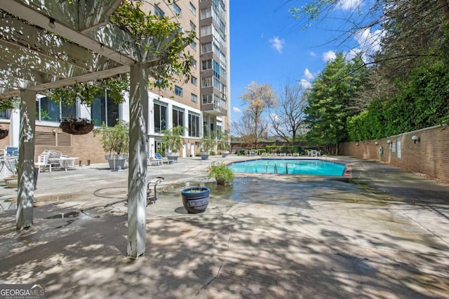 view of swimming pool featuring a pergola and a patio area