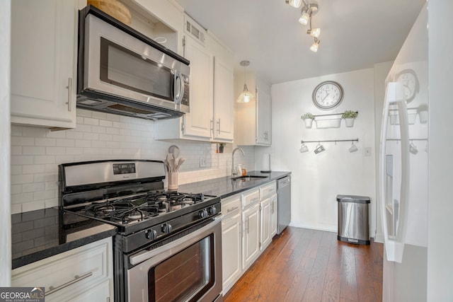 kitchen with white cabinets, dark hardwood / wood-style flooring, stainless steel appliances, and sink