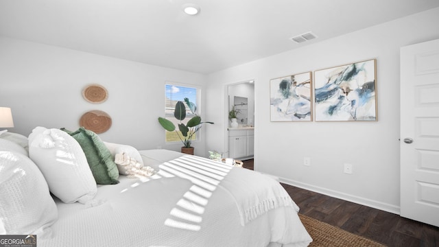 bedroom with dark hardwood / wood-style floors and connected bathroom