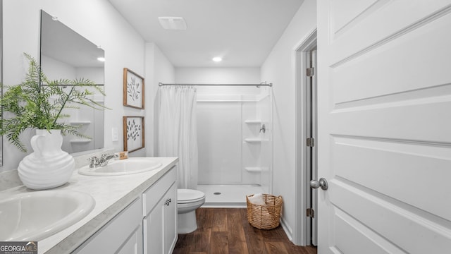 bathroom featuring vanity, hardwood / wood-style flooring, toilet, and a shower with shower curtain