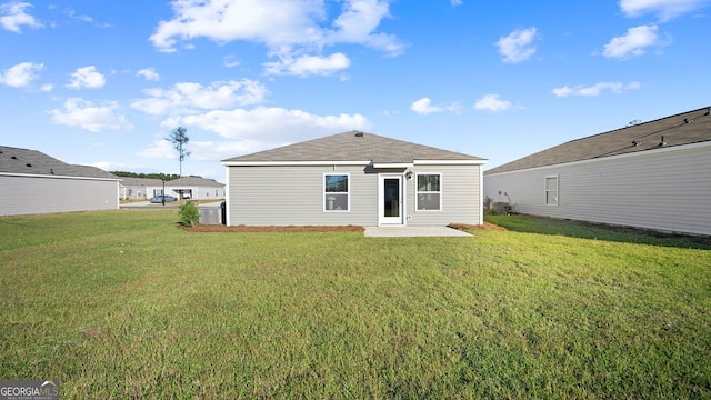 back of house with a yard and a patio area