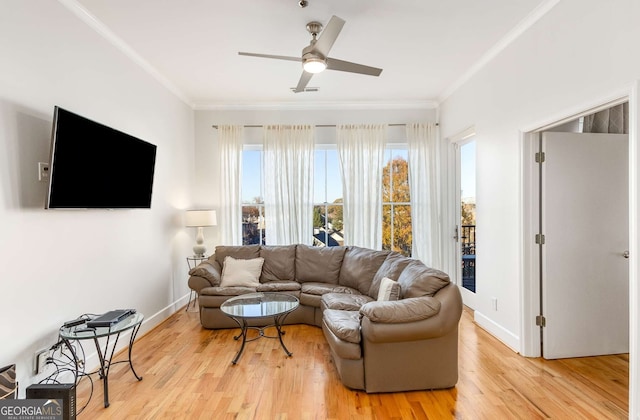 living room featuring light hardwood / wood-style flooring, ceiling fan, and ornamental molding