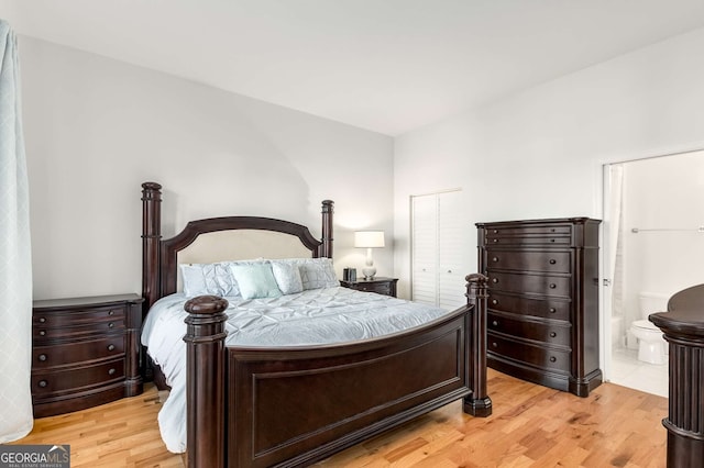 bedroom featuring ensuite bathroom, light hardwood / wood-style flooring, and a closet