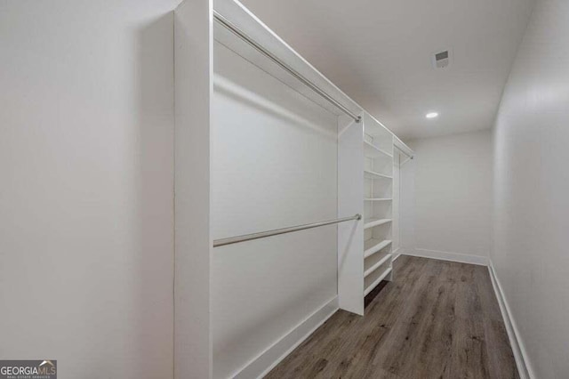 walk in closet with hardwood / wood-style floors