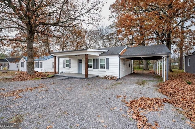 ranch-style home with a carport and covered porch