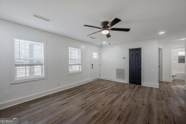 interior space with ceiling fan and dark wood-type flooring