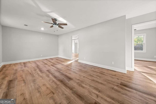 unfurnished room with wood-type flooring and ceiling fan