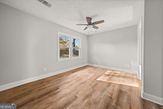 spare room featuring ceiling fan and wood-type flooring