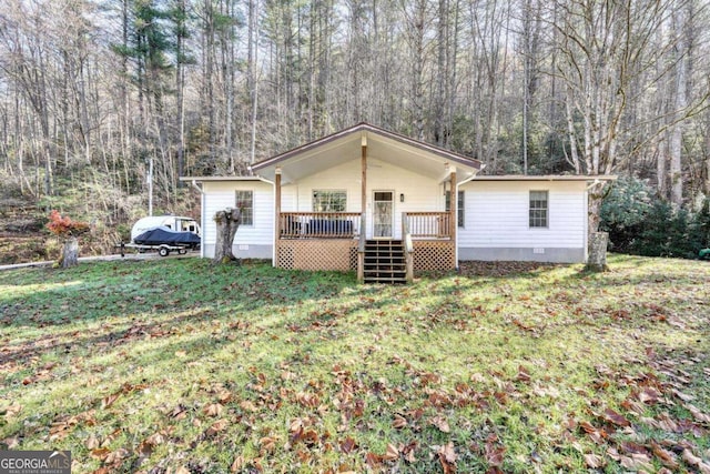 view of front of home featuring a deck and a front lawn