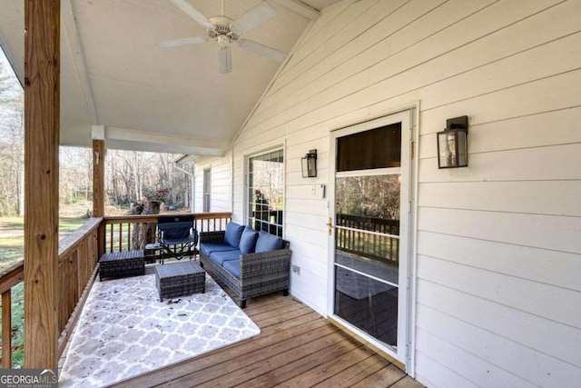 wooden terrace featuring an outdoor living space and ceiling fan