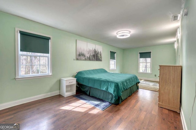 bedroom with dark wood-type flooring