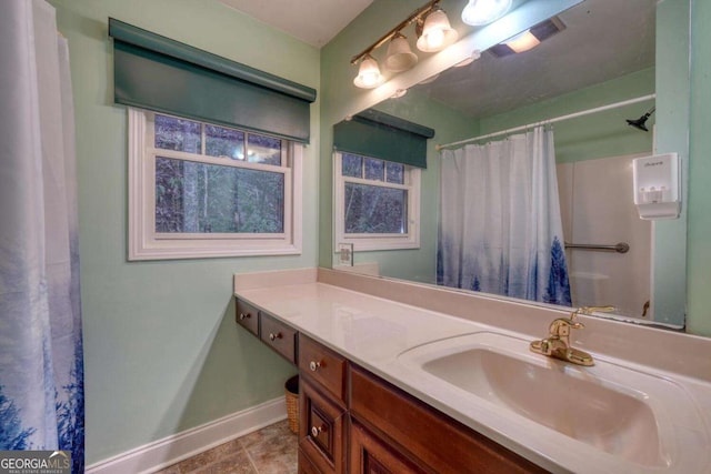 bathroom with tile patterned floors, curtained shower, and vanity