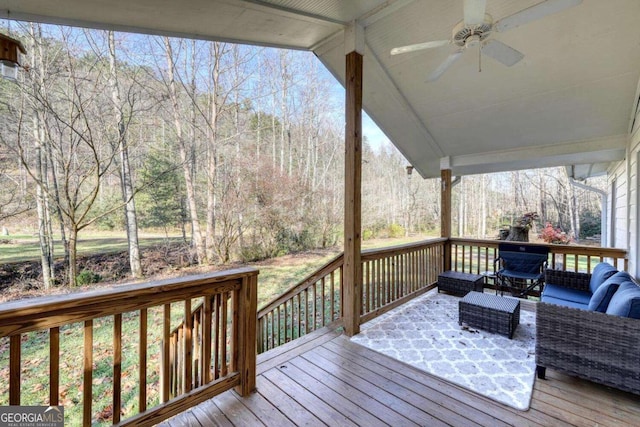 wooden terrace with outdoor lounge area and ceiling fan