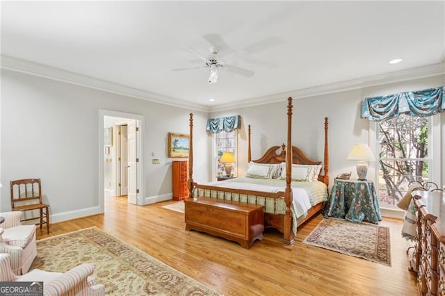 bedroom with ceiling fan, crown molding, and light hardwood / wood-style flooring