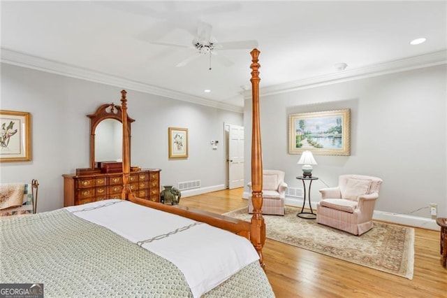 bedroom with hardwood / wood-style floors, ceiling fan, and ornamental molding