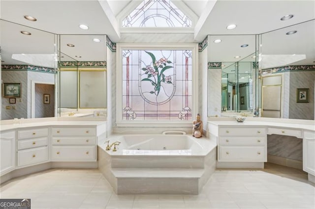 bathroom featuring tile patterned flooring, vanity, a relaxing tiled tub, and vaulted ceiling