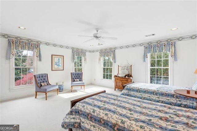 carpeted bedroom featuring ceiling fan and multiple windows