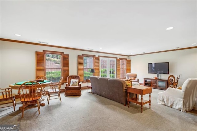 carpeted living room with french doors and crown molding