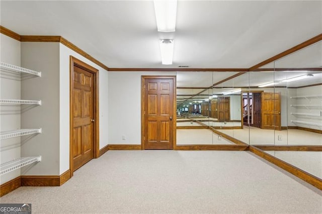 basement with light colored carpet and ornamental molding