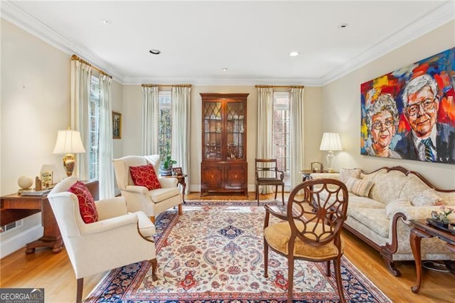 living area featuring light hardwood / wood-style floors and crown molding