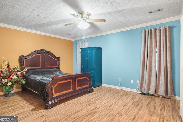 bedroom featuring hardwood / wood-style floors, ceiling fan, ornamental molding, and a textured ceiling