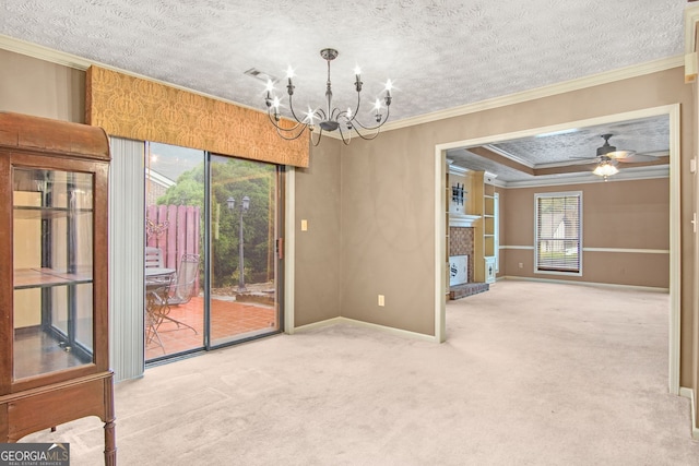 empty room featuring a textured ceiling, carpet floors, ceiling fan with notable chandelier, and ornamental molding