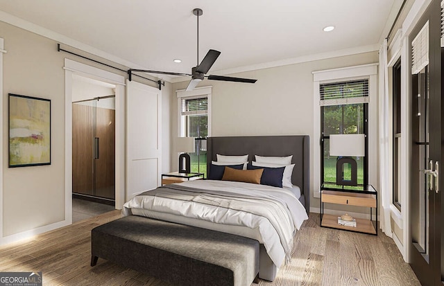 bedroom featuring hardwood / wood-style flooring, ceiling fan, and multiple windows