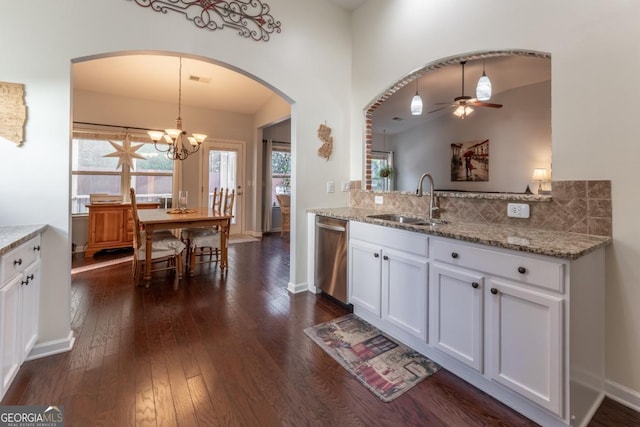 kitchen with dishwasher, dark wood-type flooring, white cabinets, sink, and hanging light fixtures