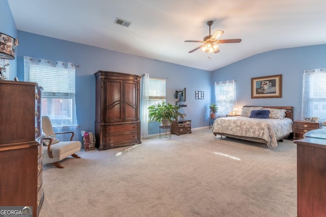 bedroom featuring ceiling fan, lofted ceiling, and light carpet