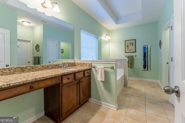 bathroom with tile patterned flooring, a bathtub, and vanity