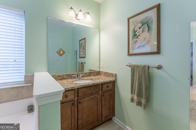 bathroom featuring a tub to relax in, tile patterned flooring, and vanity