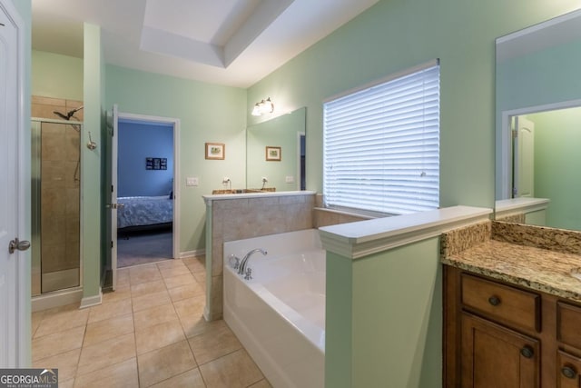 bathroom featuring tile patterned flooring, shower with separate bathtub, vanity, and a tray ceiling