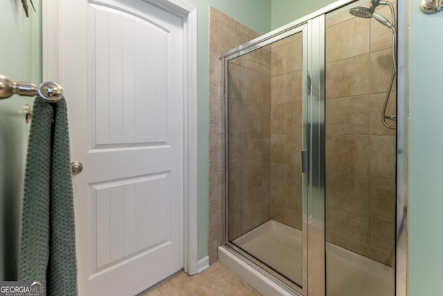 bathroom featuring tile patterned floors and a shower with door