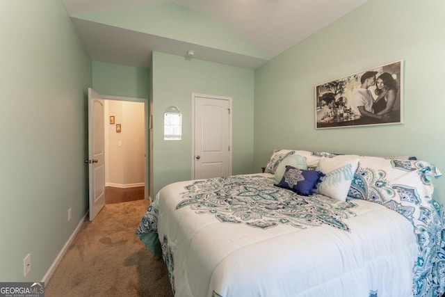 carpeted bedroom featuring vaulted ceiling