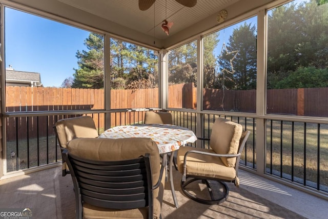 sunroom / solarium featuring ceiling fan