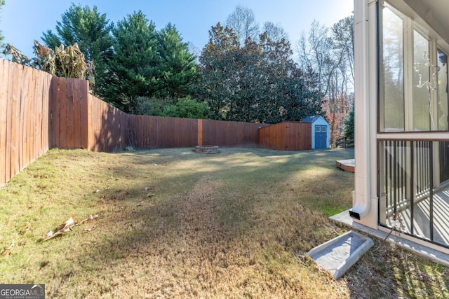 view of yard featuring a shed and an outdoor fire pit