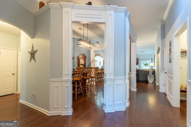 hallway featuring dark hardwood / wood-style floors and ornamental molding