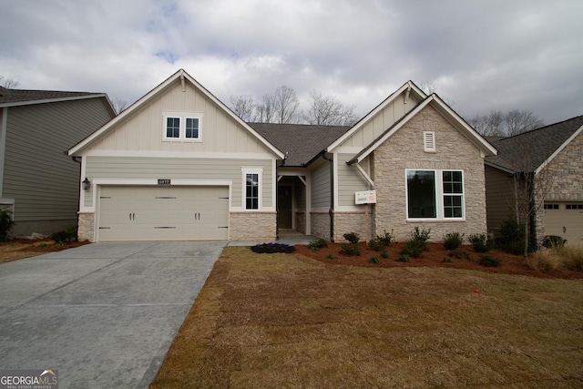 craftsman-style house featuring concrete driveway, a garage, board and batten siding, and stone siding