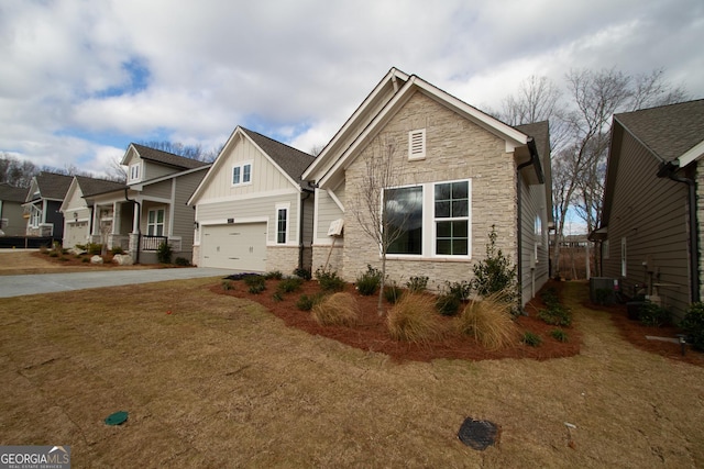 craftsman-style house featuring stone siding, board and batten siding, concrete driveway, and central AC unit